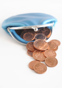 WD 1623-03 A still life image of pence coins falling out of a blue coin purse. Obligatory Credit - CAMERA PRESS / Tristan Gregory